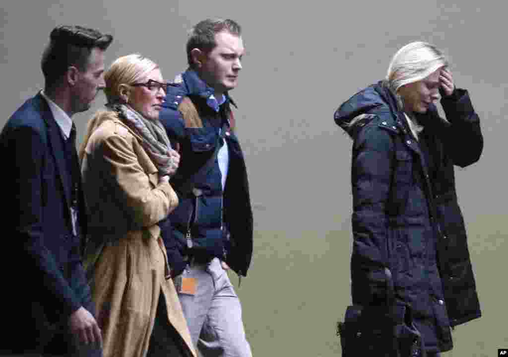 Crying people arrive at the airport in Duesseldorf, Germany after a Germanwings passenger jet carrying more than 140 people crashed in the French Alps region as it traveled from Barcelona to Duesseldorf, March 24, 2015.