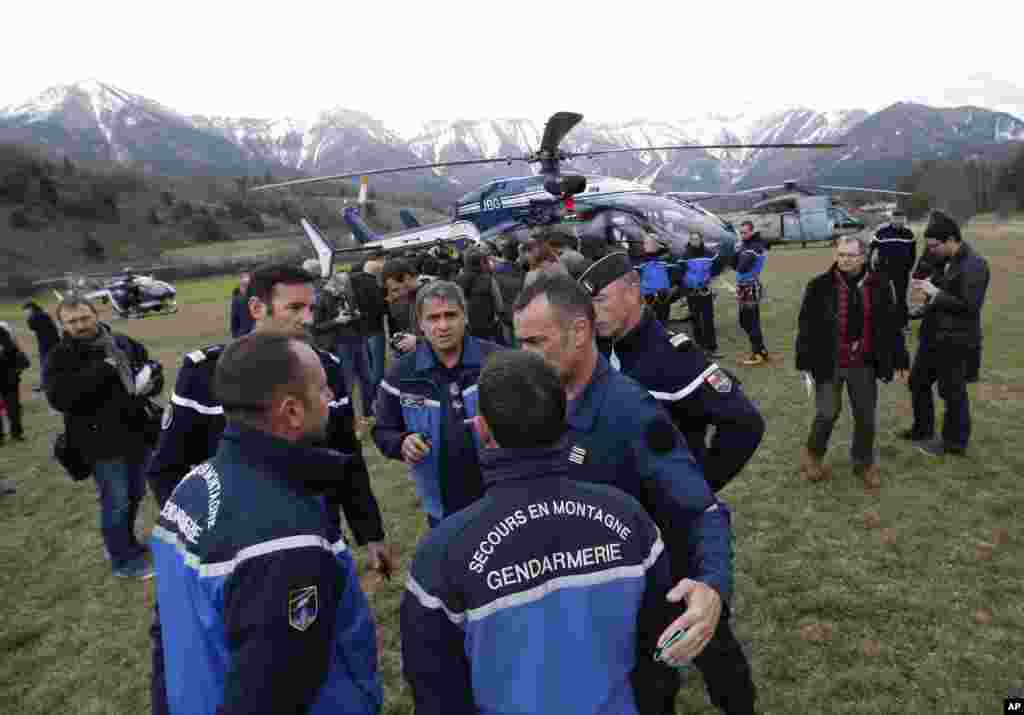 Rescue workers and gendarme gather in Seyne-les-Alpes, French Alps, as they struggle to reach the remote crash site of Germanwings passenger plane, March 24, 2015.