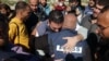 Al Jazeera's bureau chief in Gaza, Wael Al-Dahdouh (C) is comforted during the funeral of his son Hamza Wael Dahdouh, a journalist with the Al Jazeera television network, who was killed in a reported Israeli air strike, in Rafah in the Gaza Strip on Janua