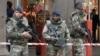 Soldiers stand guard after an attacker with a knife hidden in his bag attacked three soldiers on an anti-terror patrol in front of a Jewish community center in Nice, southern France, Feb. 3, 2015.