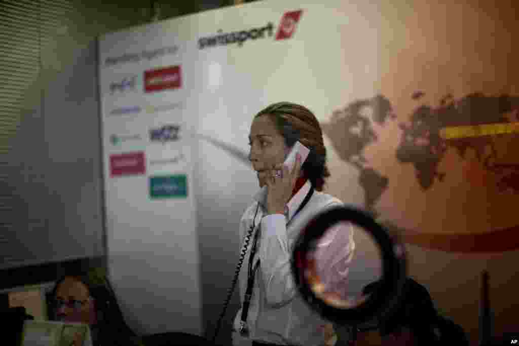 A worker from Swissport International, a ground cargo handling service that partners with Germanwings airlines, works at an office in the Barcelona Airport, Spain, March 24, 2015.